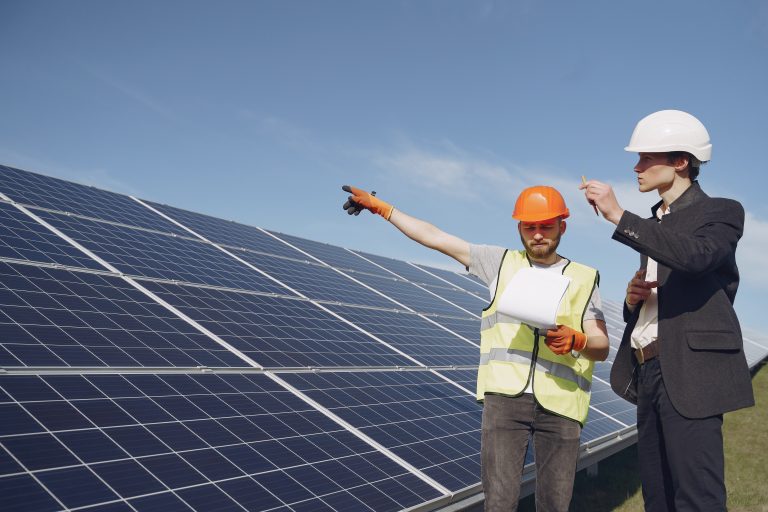 Foreman and businessman at solar energy station